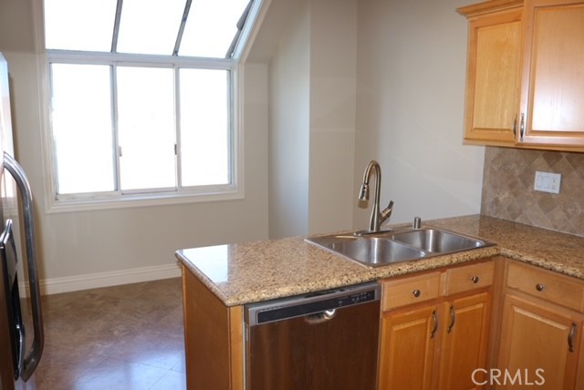 46 Los Cabos Dana Point, CA 92629 - Photo 28 of 37 a kitchen with granite countertop a sink and a window