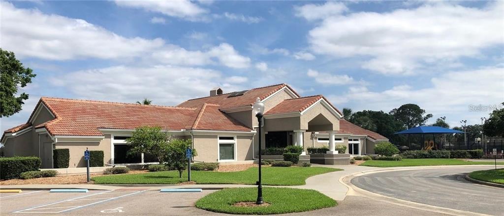 7432 Sparkling Lake Road Orlando, FL 32819 - Photo 45 of 54 a front view of a house with a yard