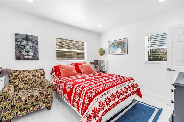 a bedroom with bed and windows