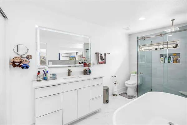 a bathroom with a sink mirror and toilet