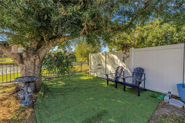 a backyard of a house with table and chairs