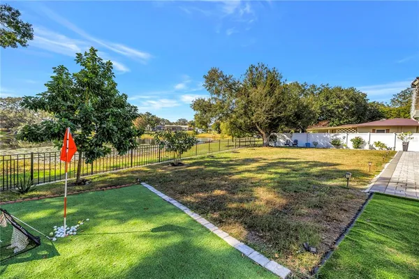 a view of a backyard with swimming pool