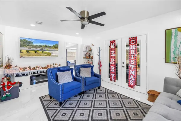 a living room with furniture a rug and a window