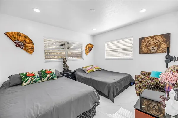 a bedroom with two beds and a chandelier