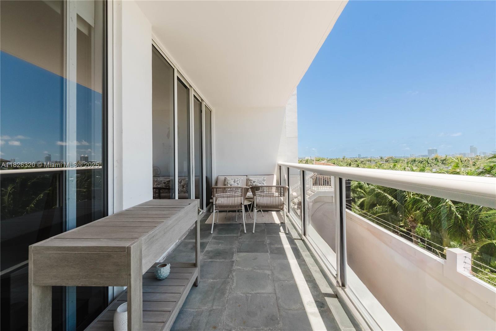 1900 Sunset Harbour Drive, Unit 703 Miami Beach, FL 33139 - Photo 14 of 22 a balcony with chairs and wooden floor