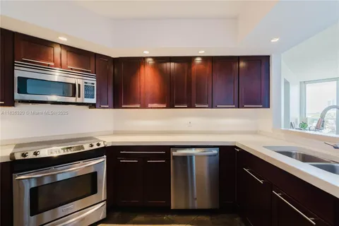 a kitchen with a sink stove and microwave