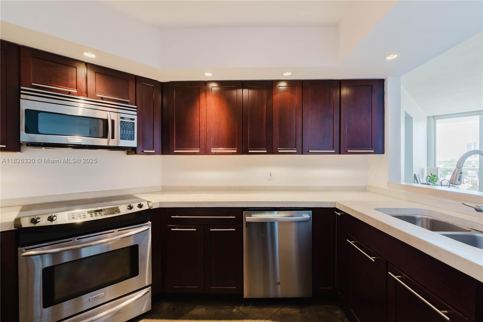 1900 Sunset Harbour Drive, Unit 703 Miami Beach, FL 33139 - Photo 5 of 22 a kitchen with a sink stove and microwave