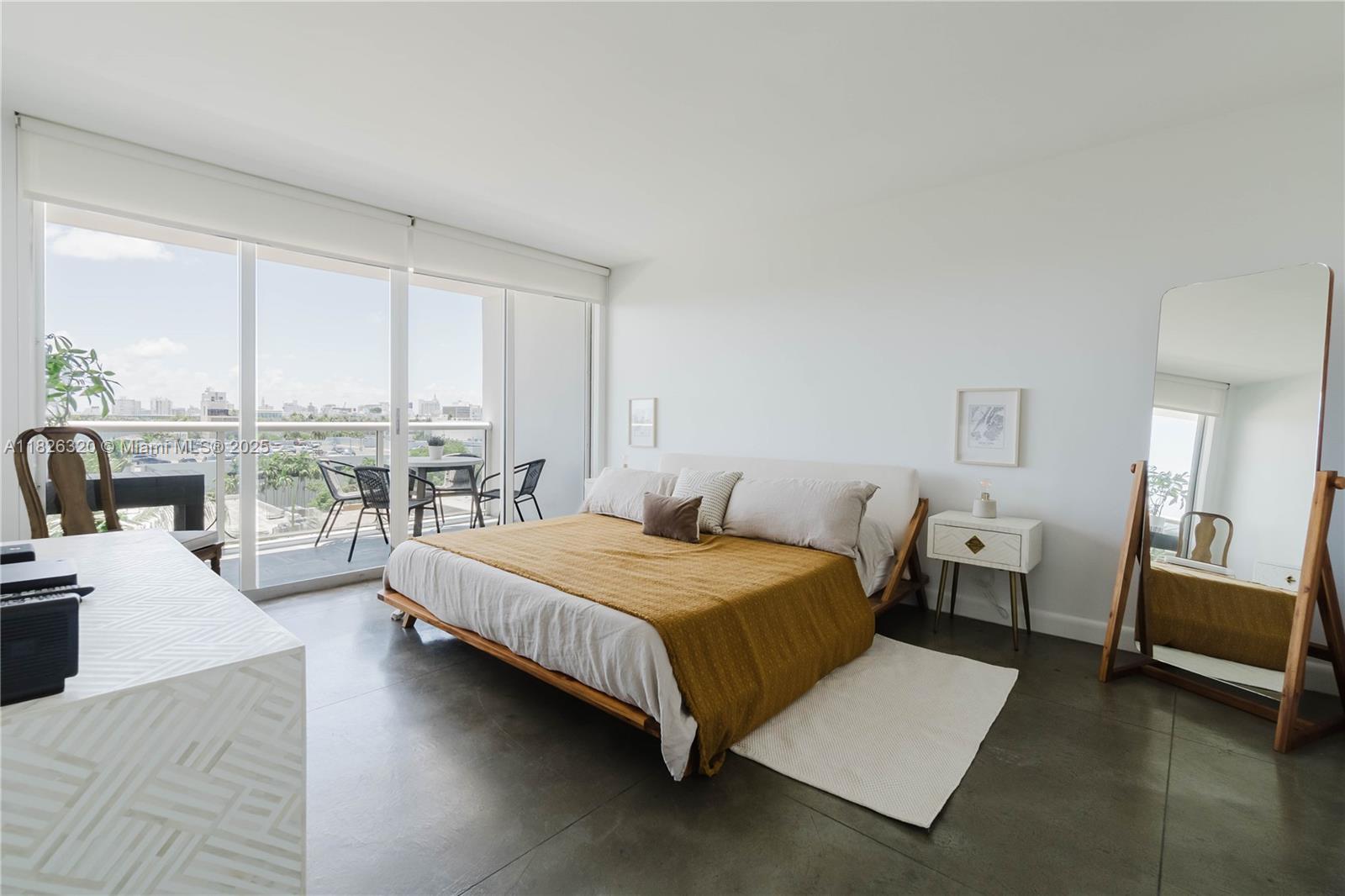 1900 Sunset Harbour Drive, Unit 703 Miami Beach, FL 33139 - Photo 6 of 22 a spacious bedroom with a bed and a large window