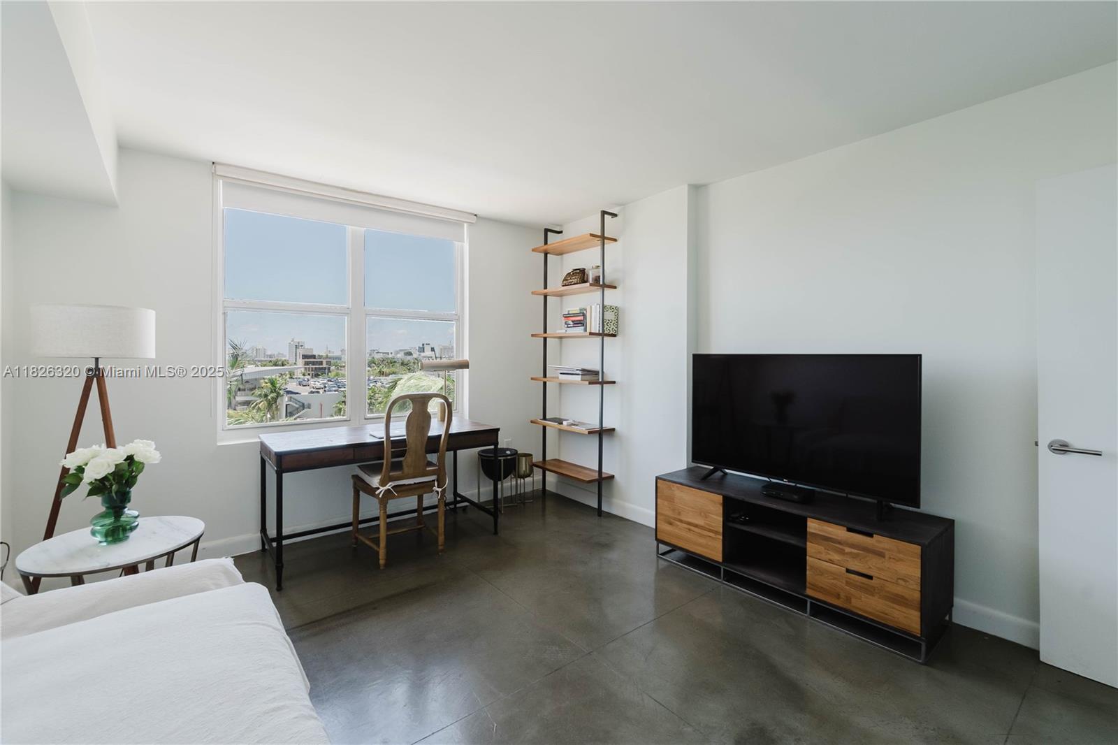 1900 Sunset Harbour Drive, Unit 703 Miami Beach, FL 33139 - Photo 10 of 22 a living room with furniture and a flat screen tv