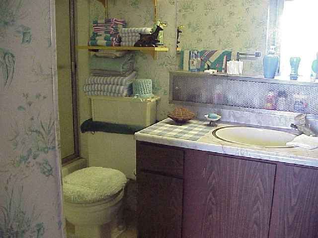 1993 South Kihei Road, Unit 615 Kihei, HI 96753 - Photo 12 of 16 a bathroom with a granite countertop toilet and a sink