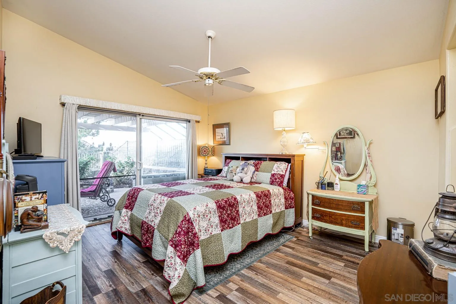 2602 Columbine Road Alpine, CA 91901 - Photo 11 of 38 a bedroom with a bed and a chandelier