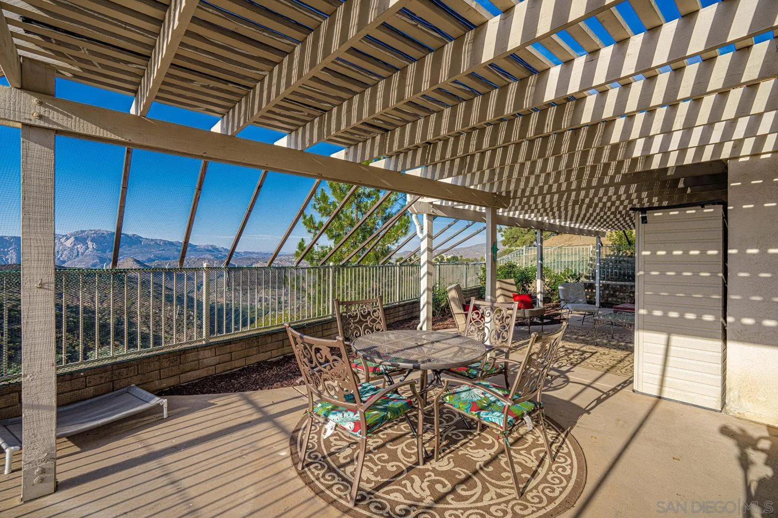 2602 Columbine Road Alpine, CA 91901 - Photo 19 of 38 a view of a patio with a table chairs and backyard