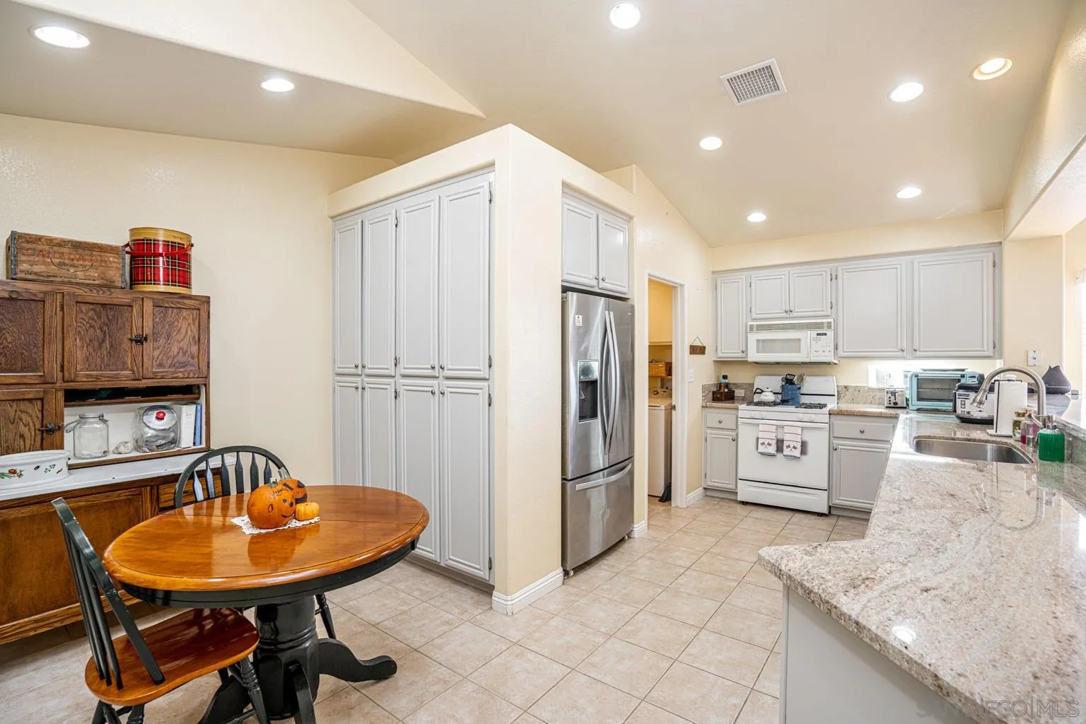 2602 Columbine Road Alpine, CA 91901 - Photo 7 of 38 a kitchen with stainless steel appliances granite countertop a sink refrigerator and cabinets