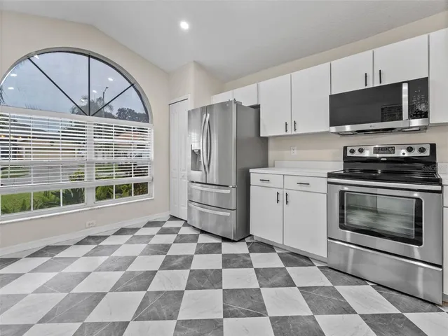 a kitchen with a stove a sink and a microwave
