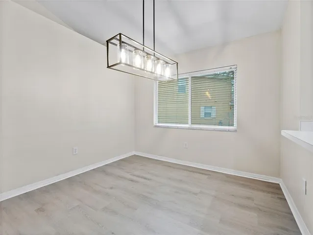 a view of a room with windows and ceiling fan