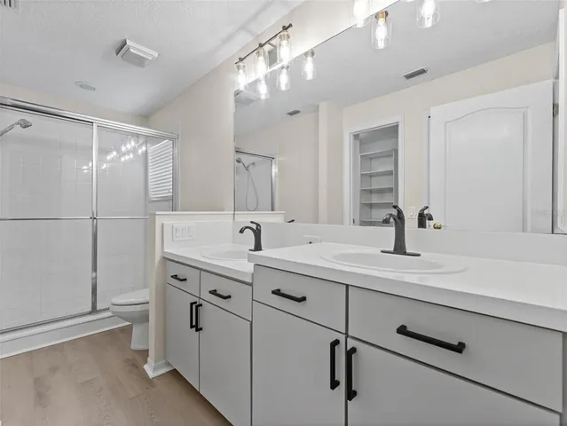 a bathroom with a double vanity sink mirror and