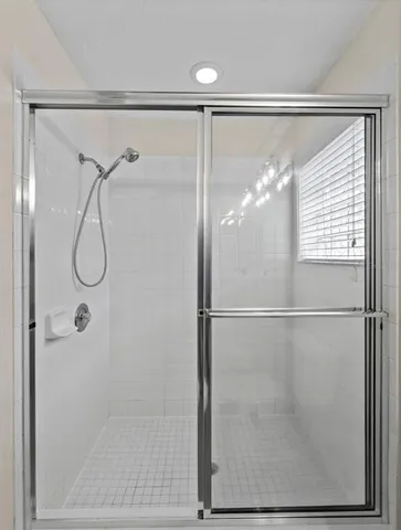 a bathroom with a glass shower door