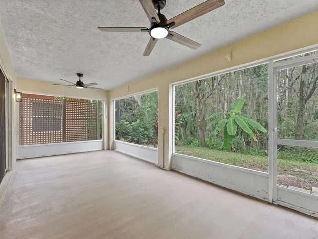 en empty room with windows and outdoor view