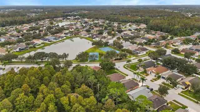 an aerial view of residential houses with outdoor space and river