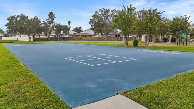 a view of a swimming pool and trees in the background
