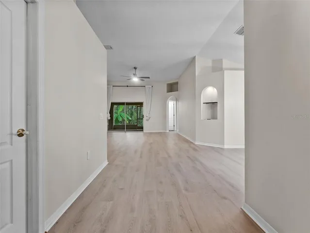 a view of a room with wooden floor and a window