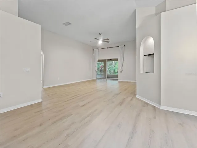 wooden floor in an empty room with a window