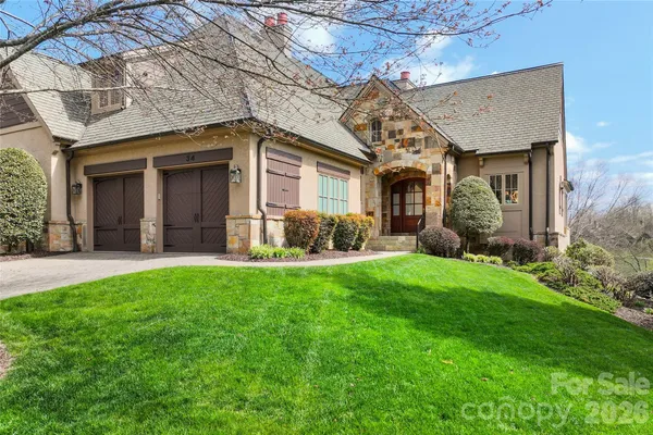 a front view of a house with a garden and plants