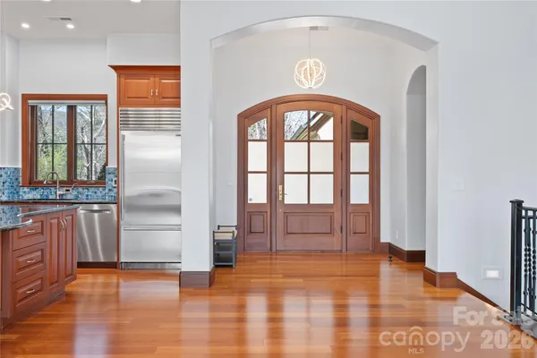 a kitchen with stainless steel appliances granite countertop a stove a sink and a refrigerator