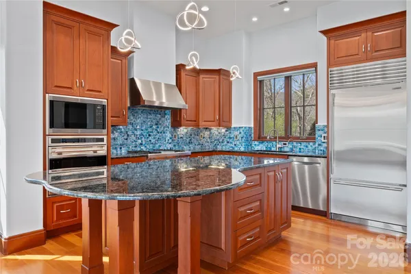 a kitchen that has a sink and a stove