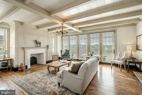 a view of a livingroom with wooden floor and stairs