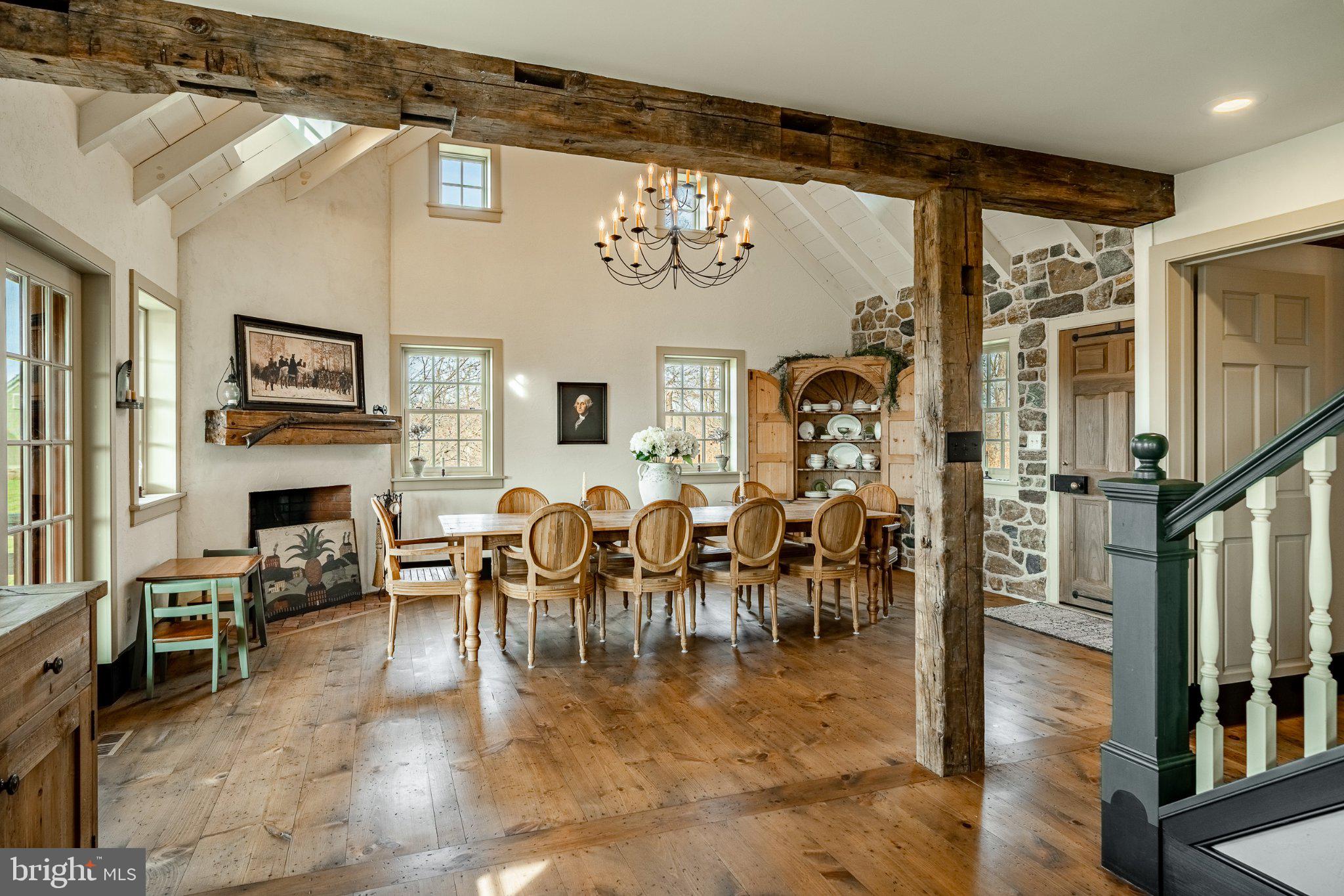 202 Privet Lane Elverson, PA 19520 - Photo 33 of 78 a dining room with furniture a fireplace and wooden floor