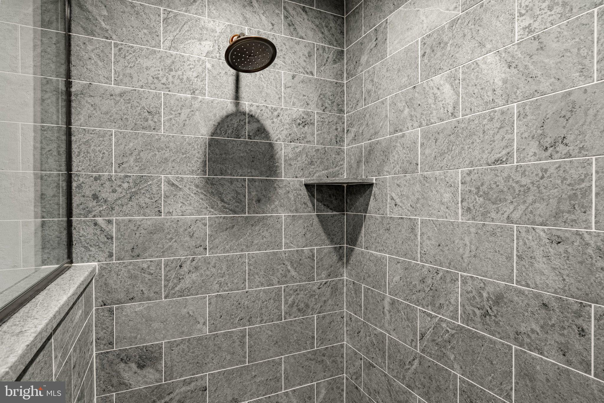202 Privet Lane Elverson, PA 19520 - Photo 64 of 78 Sleek modern shower with stone tiles.