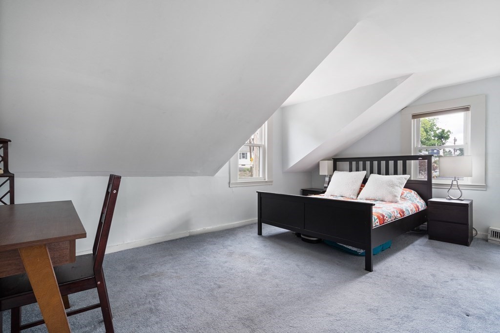 63 Hallron Street Boston, MA 02136 - Photo 14 of 32 a spacious bedroom with a bed and a chair