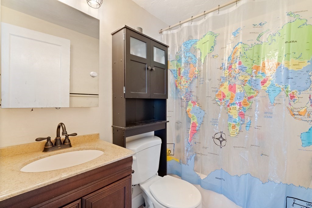 63 Hallron Street Boston, MA 02136 - Photo 18 of 32 a bathroom with a sink toilet vanity and shower