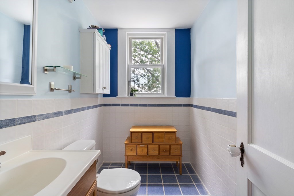 63 Hallron Street Boston, MA 02136 - Photo 24 of 32 a bathroom with a toilet a sink and a window
