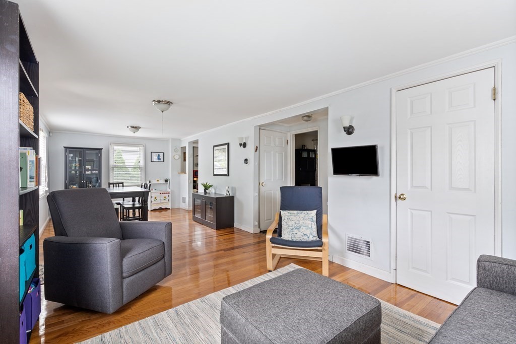 63 Hallron Street Boston, MA 02136 - Photo 4 of 32 a living room with furniture a rug and kitchen view