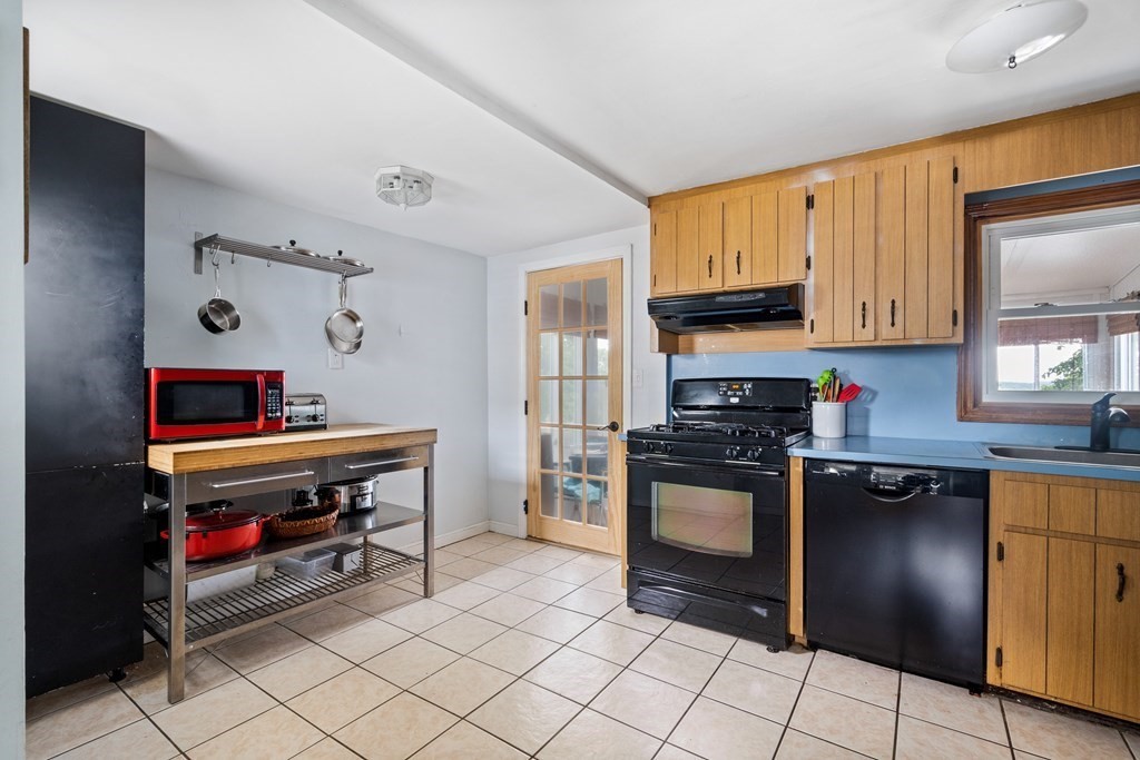 63 Hallron Street Boston, MA 02136 - Photo 7 of 32 a kitchen with stainless steel appliances a stove a sink and a refrigerator