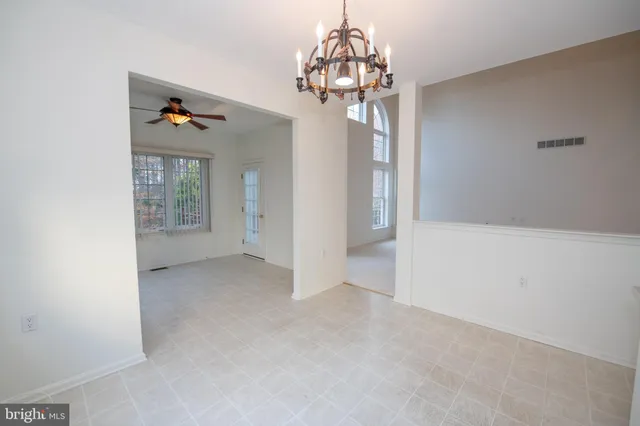 an empty room with a empty space and a ceiling fan