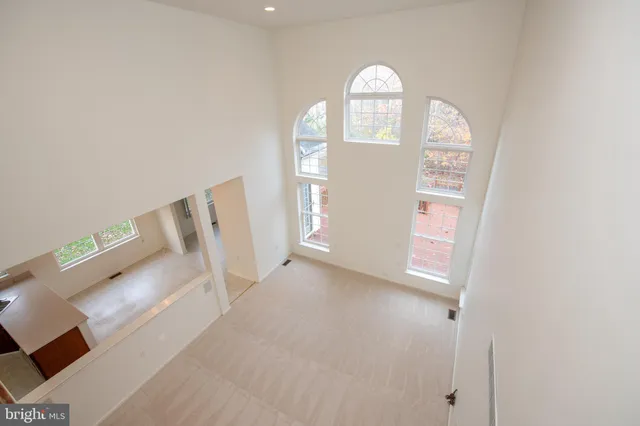 a street sign on a sidewalk next to a road