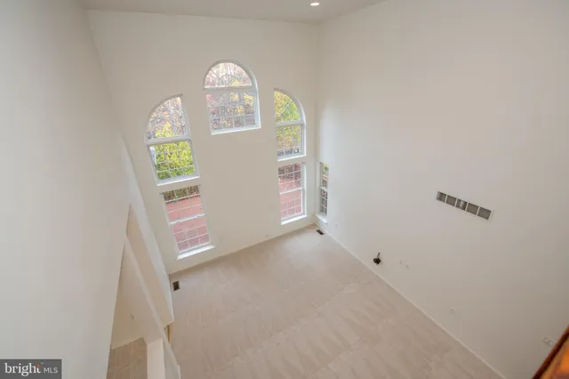 an aerial view of a house with a garden and lake view