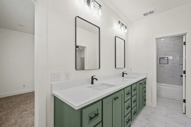 a bathroom with 2 sink and a mirror