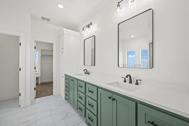 a bathroom with a double vanity sink mirror and double