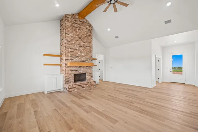 a view of an empty room with a fireplace