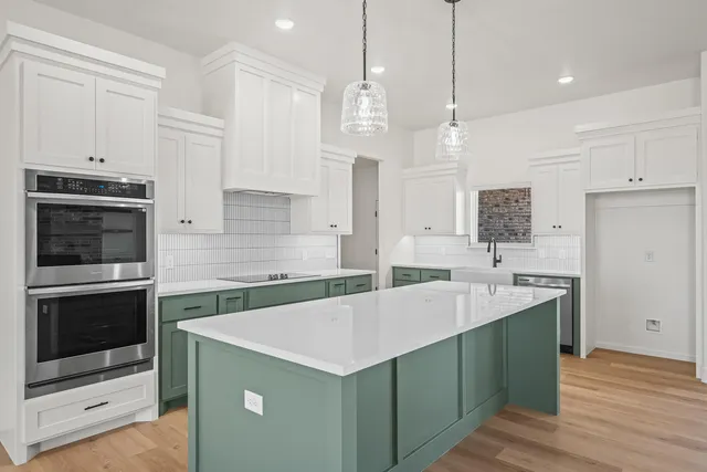 a kitchen with a stove sink and refrigerator