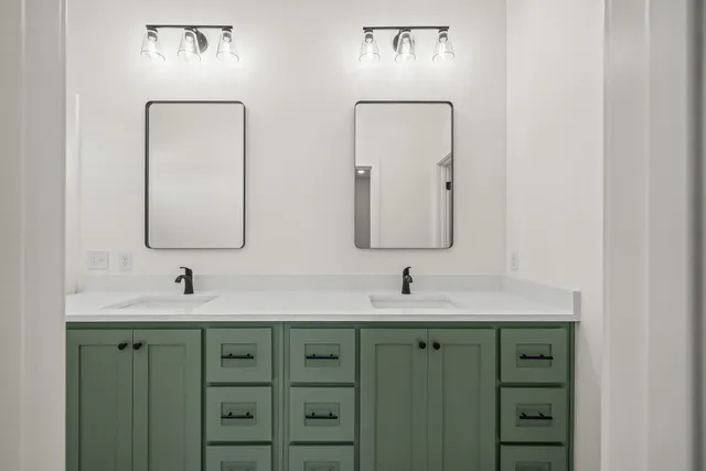 a bathroom with a double vanity sink and a mirror