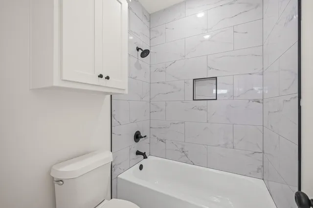 a bathroom with a bathtub and a toilet