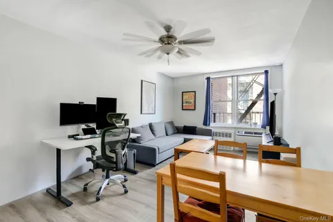 a view of a livingroom with workspace and a window