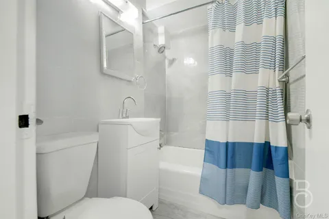 a bathroom with a toilet a sink and bathtub
