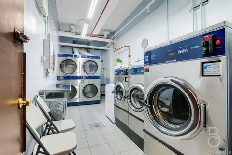 a utility room with dryer washer and other items