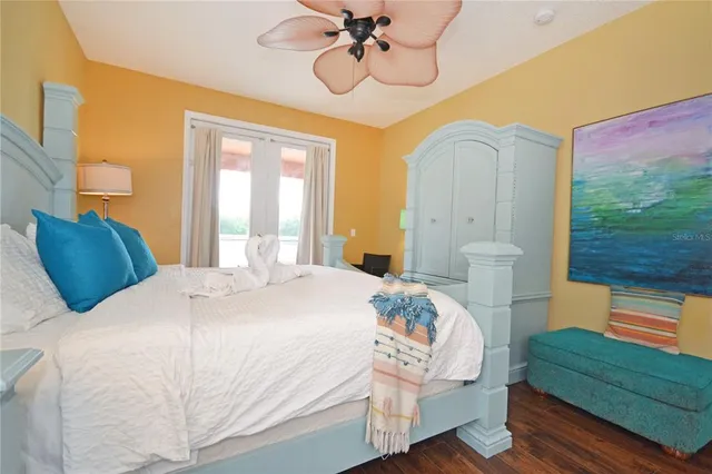 a bedroom with a bed and painting on the wall